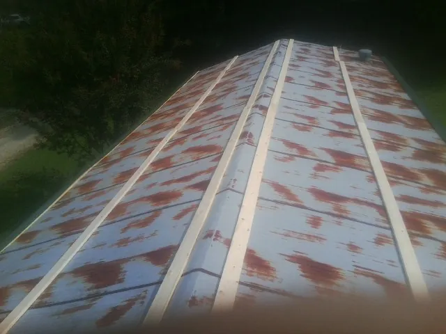 Rusted metal roof panels with new wood purlins before replacement — Storm Damage Roof Repair in Grangeville by Roofing Brothers
