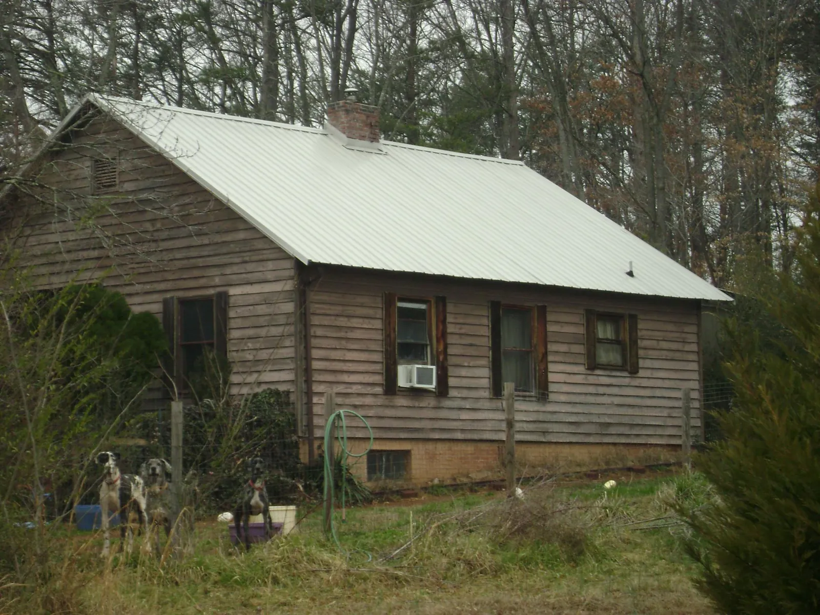 White metal roof on an old wood sided farmhouse, from a Metal Roof Installation job in Grangeville